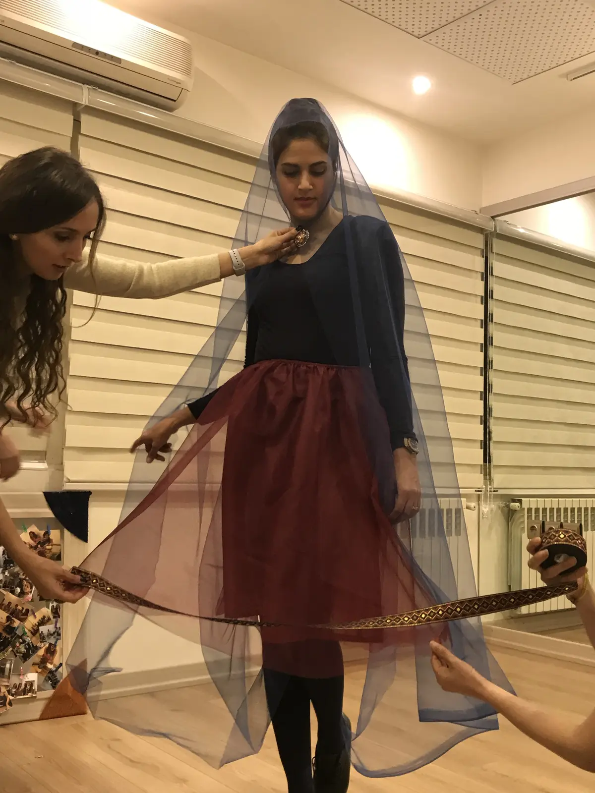 A Miniature costume fitting in progress in the studio