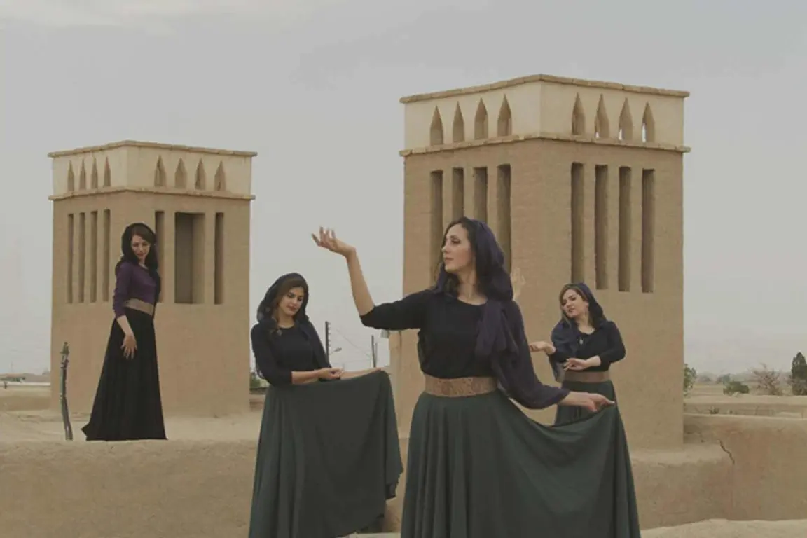 Four members of Miniature Dance Collective performing on a Tehran rooftop