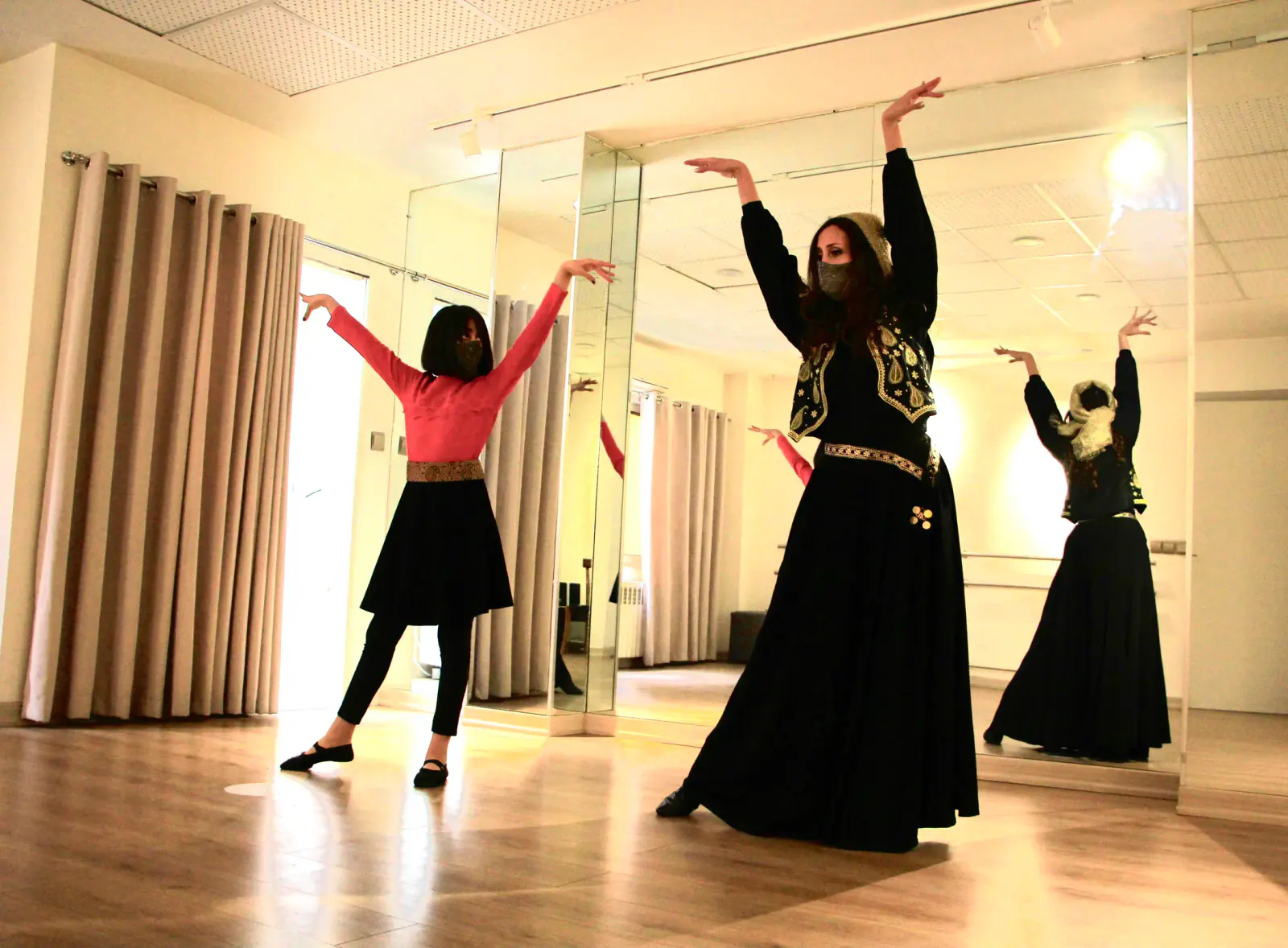 Banafsheh Amiri dancing with a student during the pandemic